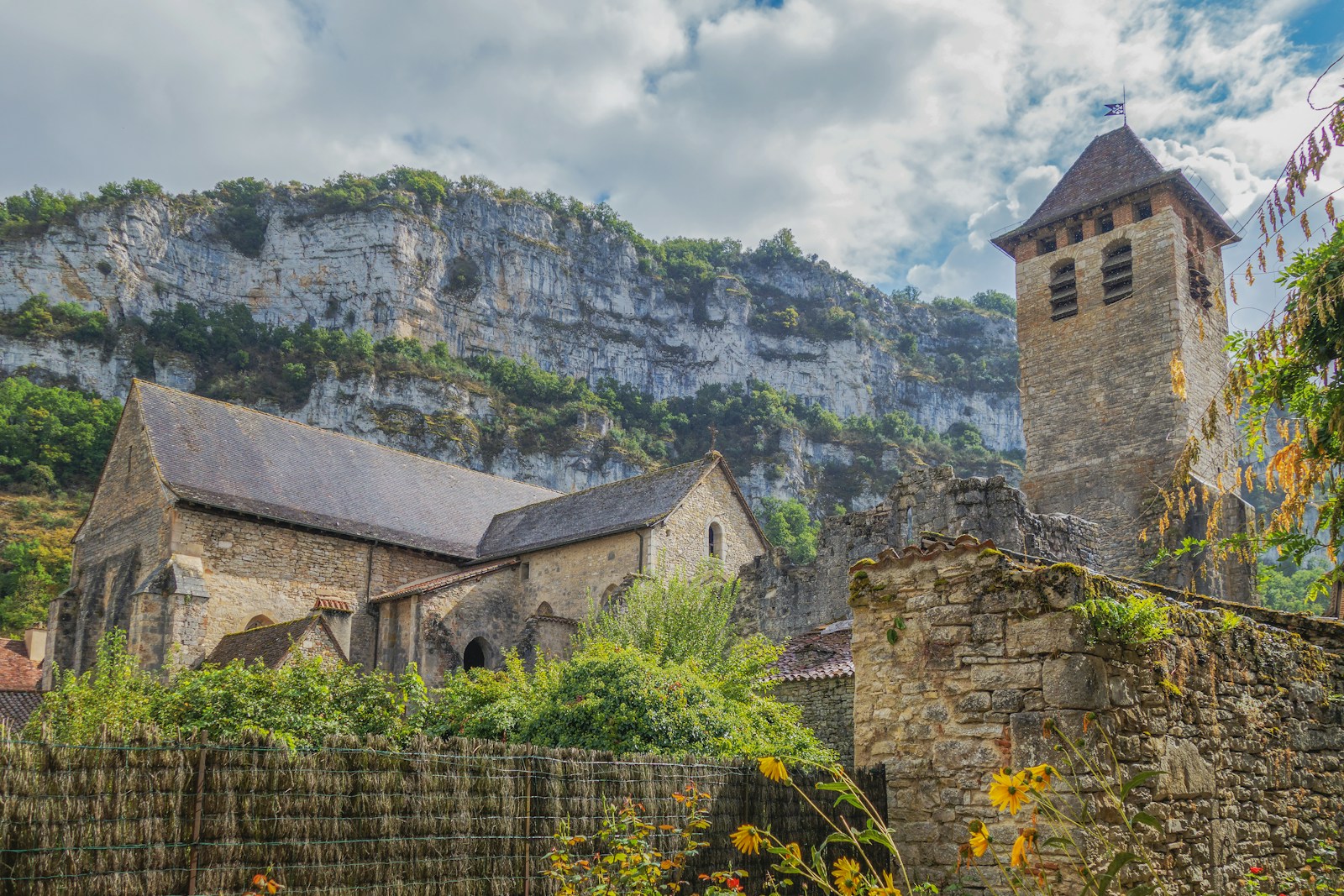 a stone church with a steeple in the background